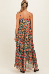 woman wearing a floral maternity maxi dress with adjustable spaghetti straps and a flowy silhouette from the back