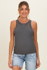 woman wearing a black and white striped maternity tank top and distressed denim shorts