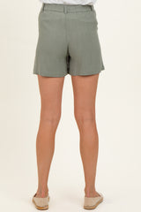 woman wearing light green maternity shorts, viewed from the back