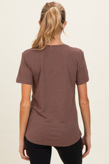 woman wearing a brown short sleeve maternity top viewed from the back
