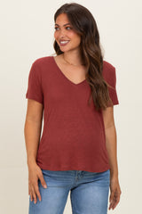 woman wearing a rust v-neck maternity t-shirt with short sleeves and relaxed fit