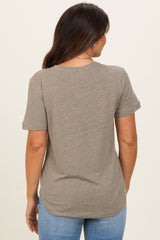 woman wearing a taupe short sleeve maternity top, showing the back view with a relaxed fit