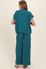 woman wearing a teal striped maternity lounge set with relaxed fit top and wide-leg pants