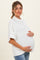 woman wearing a white short sleeve maternity sweater and holding her baby bump