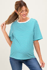woman wearing a teal and white striped maternity t-shirt with a relaxed fit and denim jeans