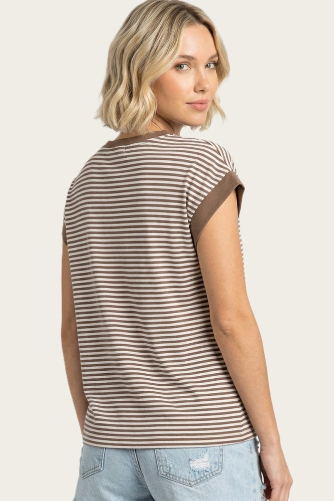 woman wearing a brown and cream striped short sleeve top, showing the back view with rolled cuff details
