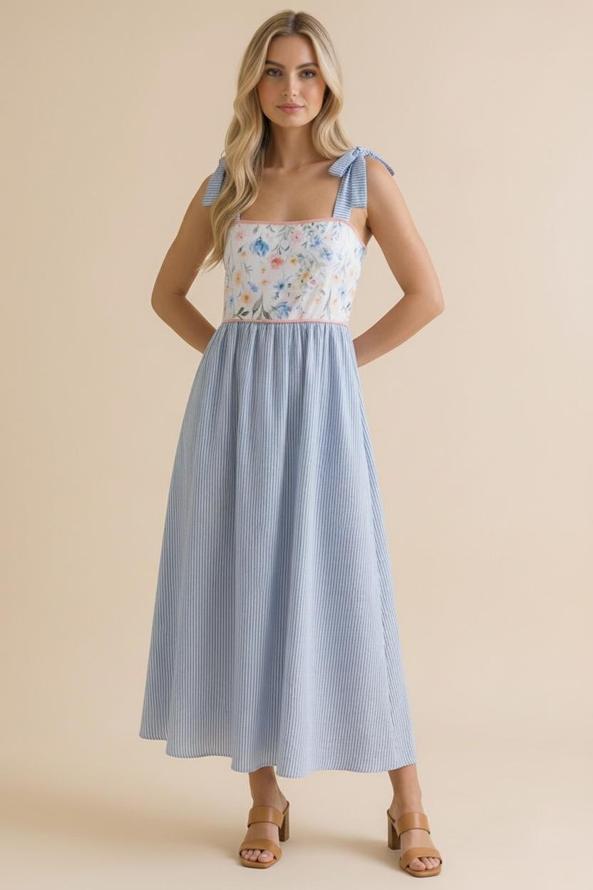woman wearing a floral and striped midi dress with tie straps and a fitted bodice