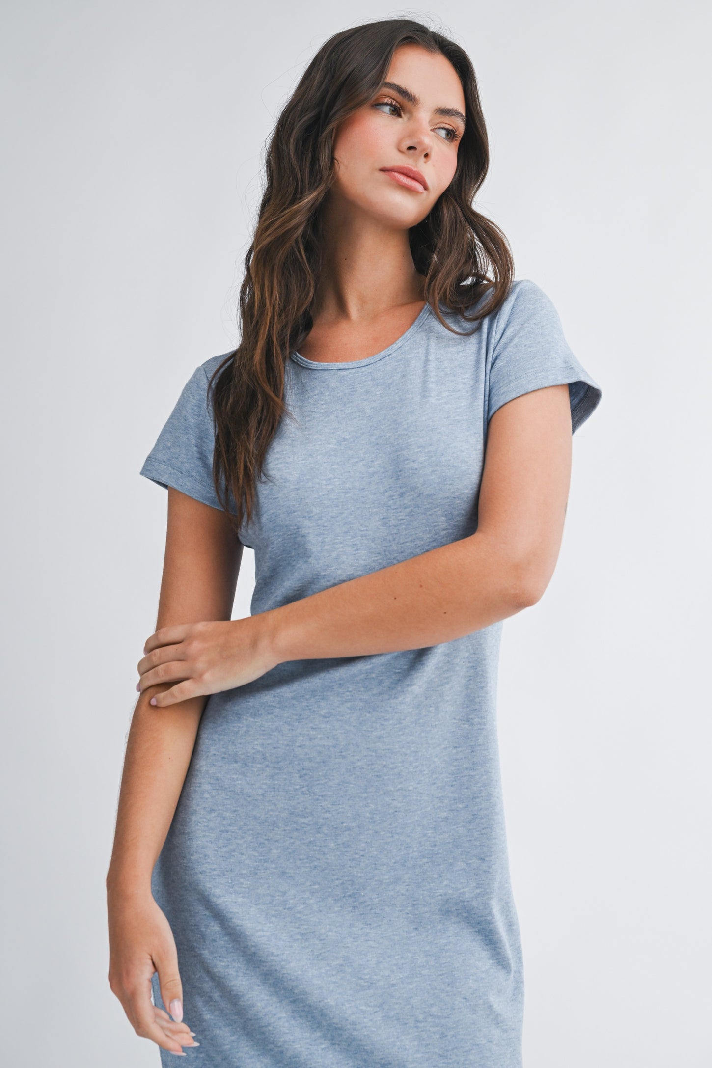 woman wearing a light blue short sleeve dress with a relaxed fit and crew neckline