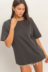 woman wearing a gray oversized t-shirt with short sleeves and distressed hemline