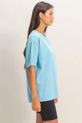 woman wearing a light blue oversized t-shirt paired with black bike shorts