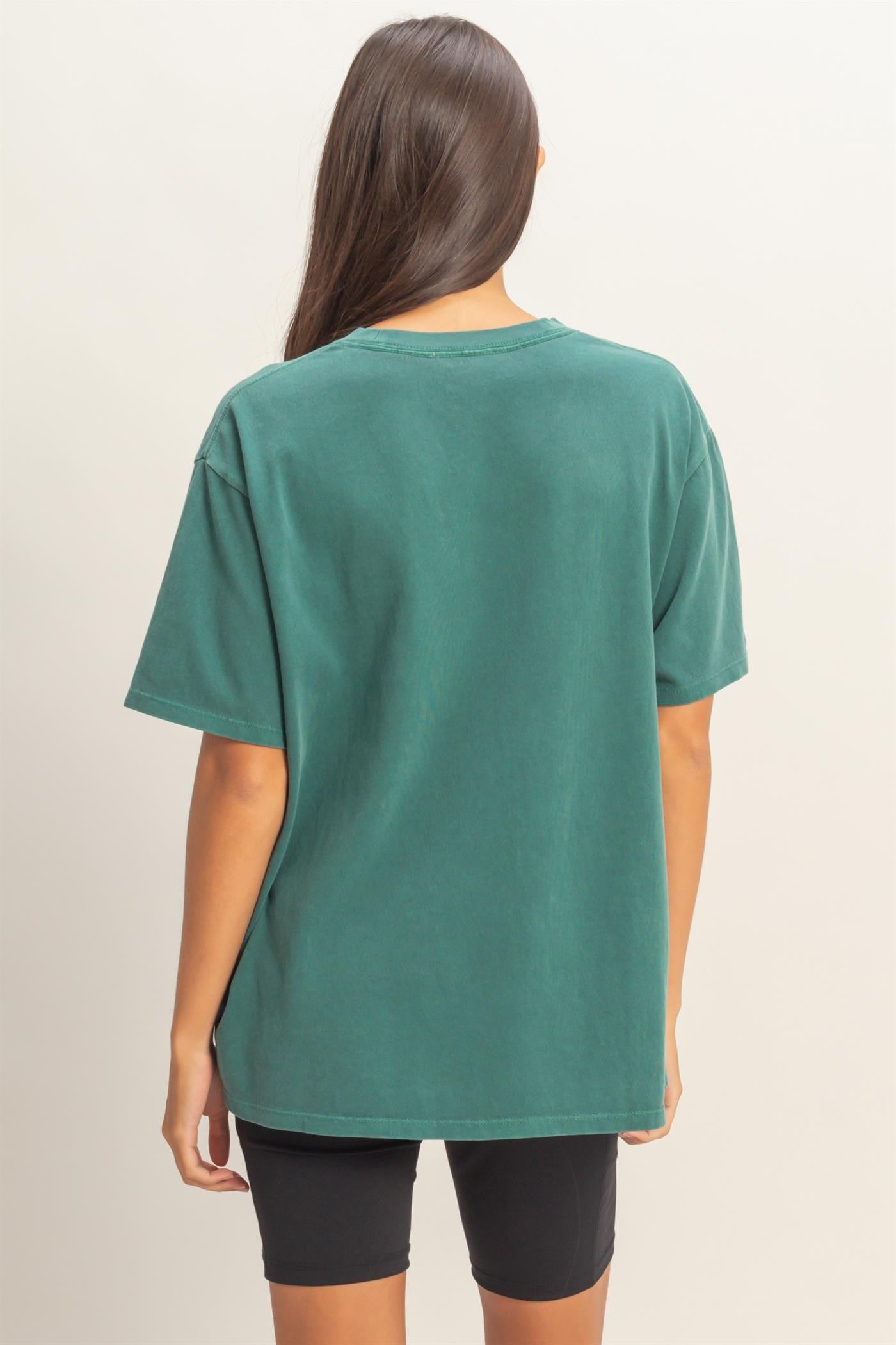 woman wearing a green oversized t-shirt with a relaxed fit and short sleeves, viewed from the back