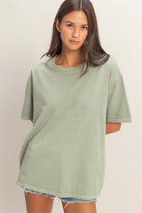 woman wearing a light green oversized t-shirt with short sleeves and a relaxed fit