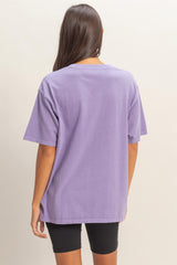 woman wearing a purple oversized t-shirt paired with black bike shorts, viewed from the back