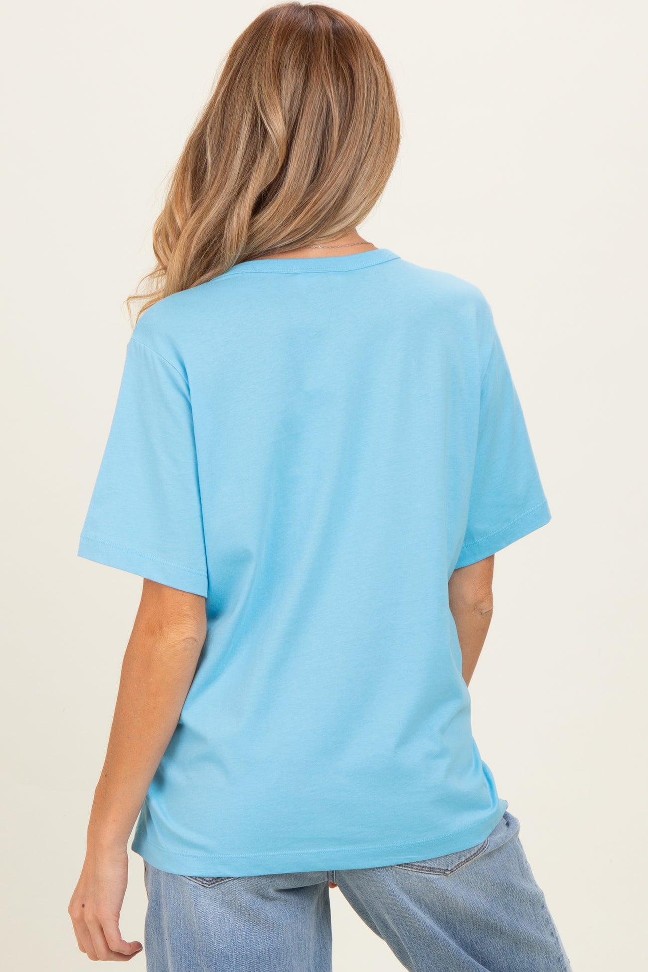 woman wearing a light blue short sleeve maternity t-shirt, shown from the back