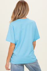 woman wearing a light blue short sleeve maternity t-shirt, shown from the back