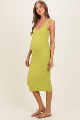 woman wearing a lime green ribbed maternity dress that hugs her baby bump