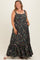 woman wearing a black floral print maternity plus maxi dress with a tiered skirt and pockets