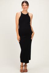 woman wearing a black ribbed maternity maxi dress showing her baby bump