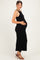 woman wearing a black ribbed maternity dress and showing her baby bump