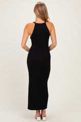 woman wearing a black ribbed maxi dress with a racerback style, shown from the back
