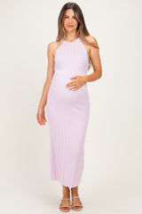 woman wearing a light purple ribbed maternity dress and holding her baby bump