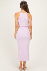 woman wearing a lavender ribbed maternity dress with a form-fitting silhouette and a mid-calf length