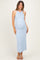woman wearing a light blue ribbed maternity dress, showcasing her baby bump and styled with straps and a fitted silhouette