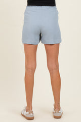 woman wearing light blue maternity shorts with a comfortable elastic waistband, shown from the back