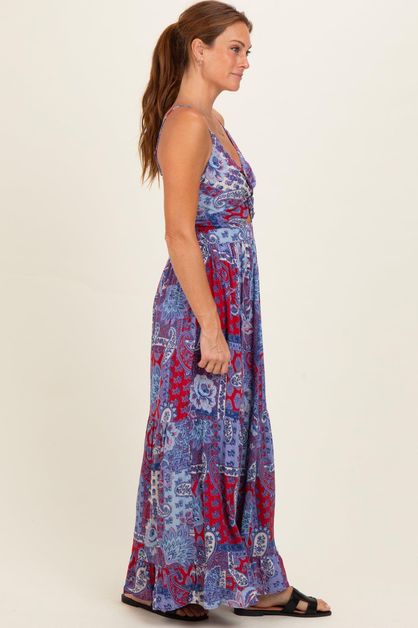 woman wearing a purple and red patterned maxi dress with a v-neckline and adjustable straps