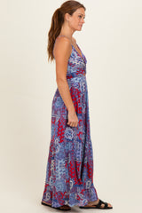 woman wearing a purple and red patterned maxi dress with a v-neckline and adjustable straps