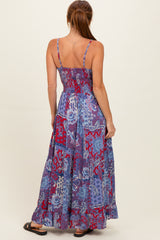 woman wearing a blue and red patterned maxi dress with a smocked back and adjustable straps