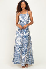 woman wearing a blue and white patterned maxi dress with spaghetti straps