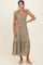 woman wearing a sage green maxi dress with ruffled straps and embroidered floral details