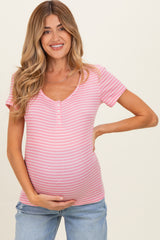 woman wearing a pink and white striped maternity top with short sleeves and a baby bump