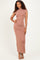 woman wearing a rose gold short sleeve bodycon maxi dress with a high neckline and a sleek silhouette