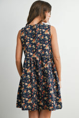 woman wearing a navy floral sleeveless dress with a fitted bodice and flared skirt, seen from the back