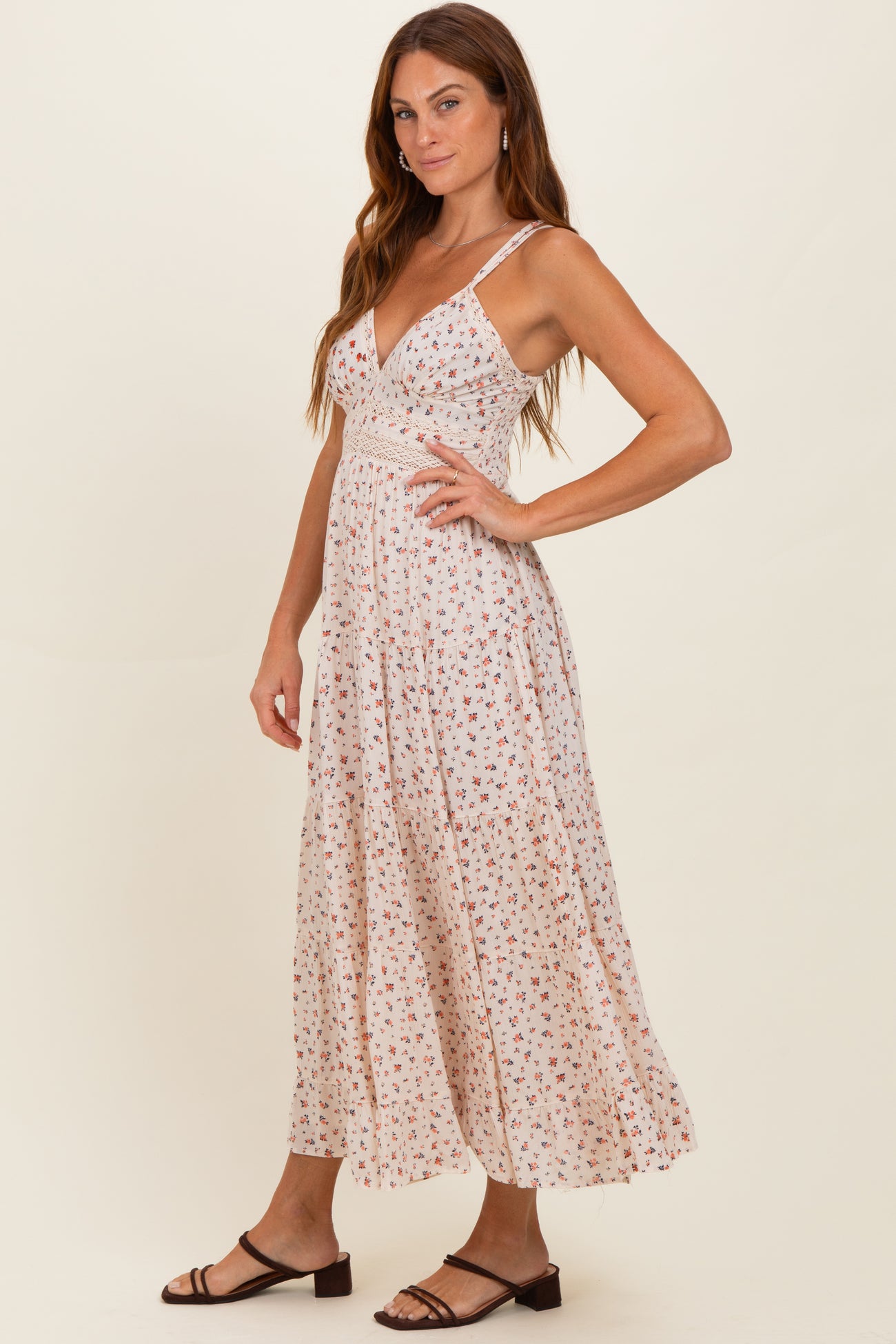 woman wearing a floral print maxi dress with a v-neckline and spaghetti straps