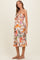 woman wearing a floral strapless maternity dress with a baby bump