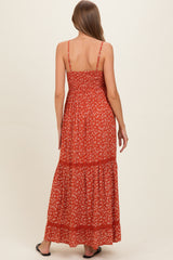 woman wearing a red floral maternity maxi dress with adjustable straps and smocked back detail