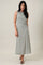 woman wearing a sleeveless midi dress with a wrap style and geometric print in green and white