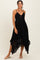 woman wearing a black lace midi dress with spaghetti straps and a high-low hemline
