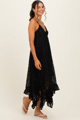 woman wearing a black lace maxi dress with a high-low hemline and spaghetti straps
