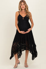 woman wearing a black lace maternity dress with a high-low hem and a baby bump visible