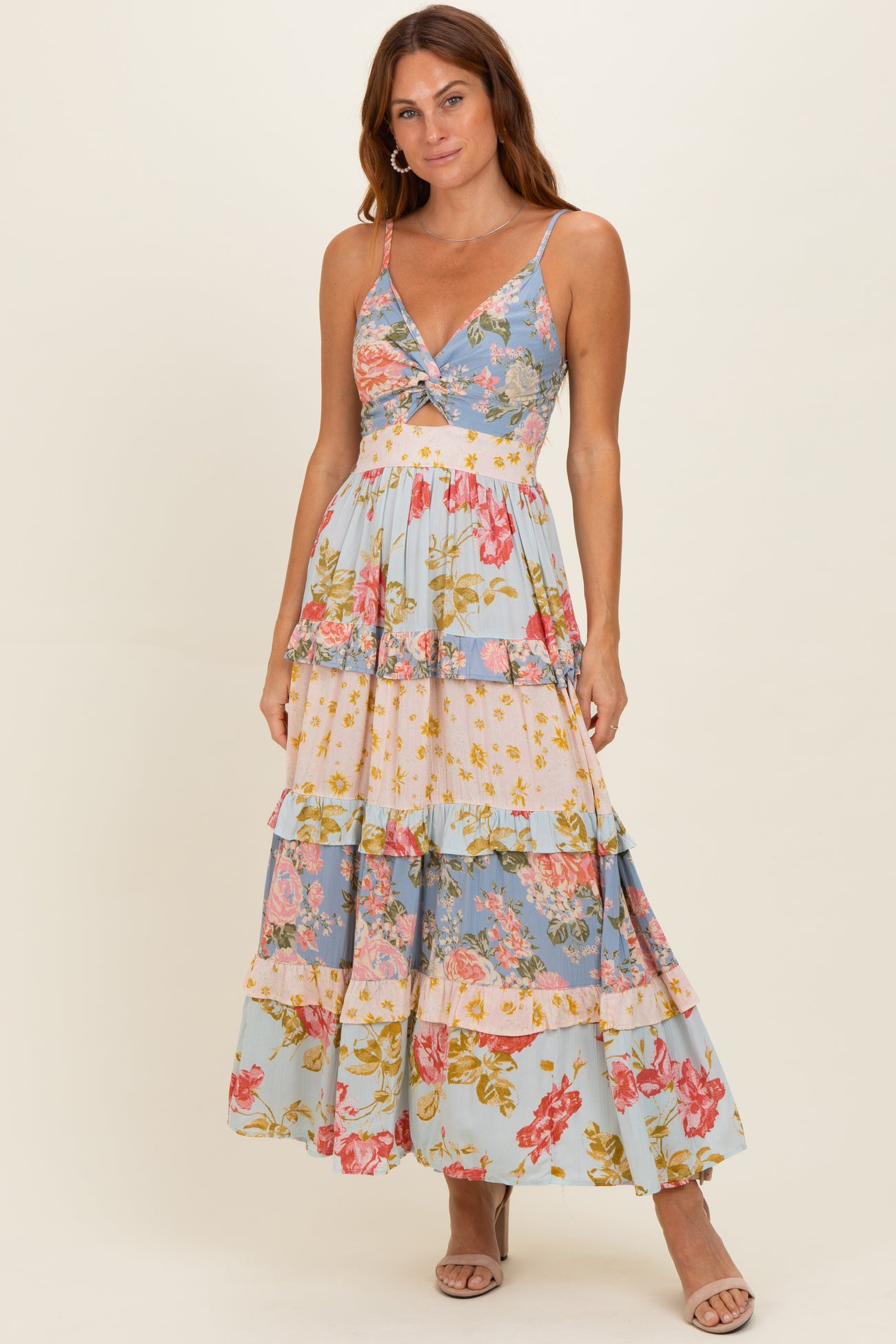 woman wearing a floral tiered maxi dress with adjustable spaghetti straps and a v-neckline