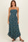 woman wearing a blue floral maxi dress with adjustable straps and a ruffled hemline