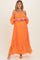 woman wearing a vibrant orange off-the-shoulder maternity dress with puff sleeves and a ruffled hemline