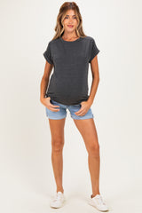 woman wearing a dark gray maternity t-shirt and denim shorts, showcasing her baby bump
