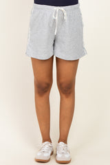 woman wearing gray maternity shorts with a drawstring waistband and side tape details