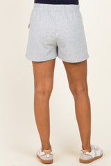 woman wearing gray maternity shorts with an elastic waistband and pockets, viewed from the back