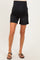 maternity wear black denim maternity shorts with a supportive belly band, model wearing sandals